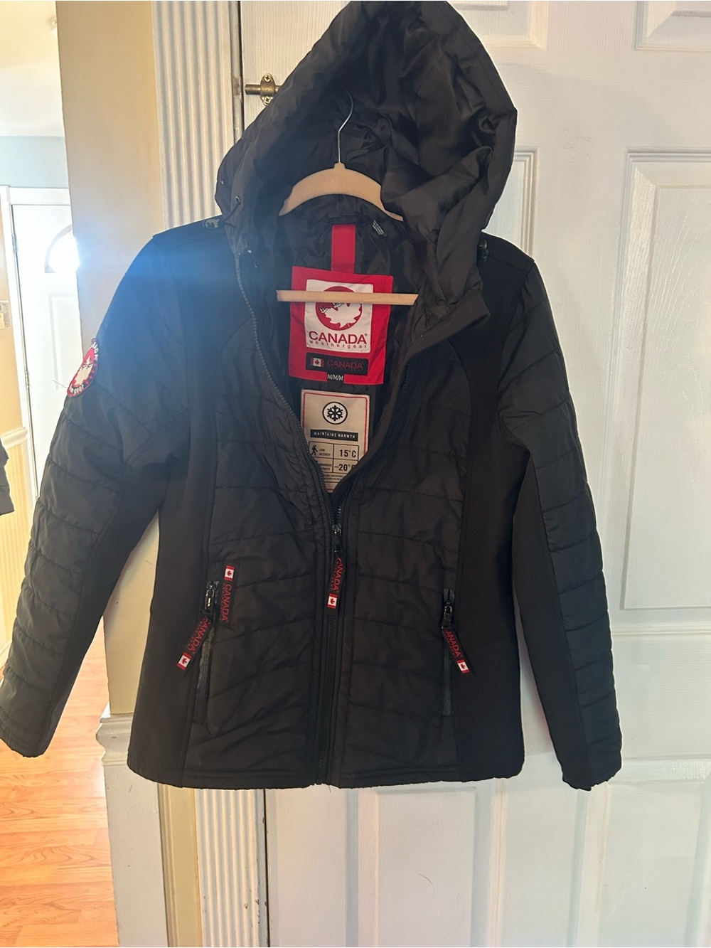 Canada Weather Gear quilted jacket featuring a cozy hood and distinctive red zip